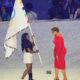 Biles held the Olympic flag with Los Angeles mayor Karen Bass during the handoff for the 2028 Olympics walking in one left foot boot… See reason